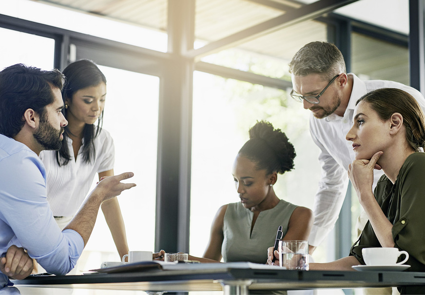 Shot of a group of colleagues working together in an office.